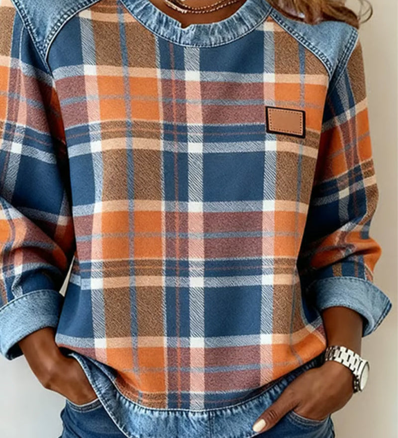 Women’s flannel pullover with plaid print, denim trim collar, and chest patch