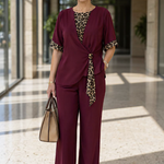 Burgundy two-piece pantsuit with V-neck top and leopard-print tie detail