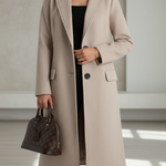 Women’s beige long tailored coat with notched lapels, front buttons, and flap pockets