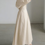 Beige long button-front dress with puff sleeves and waist tie, flowing A-line hem