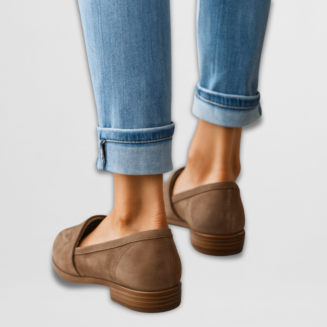 Brown suede leather moccasin loafers viewed from heel, with low stacked heel.