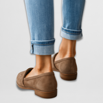 Brown suede leather moccasin loafers viewed from heel, with low stacked heel.