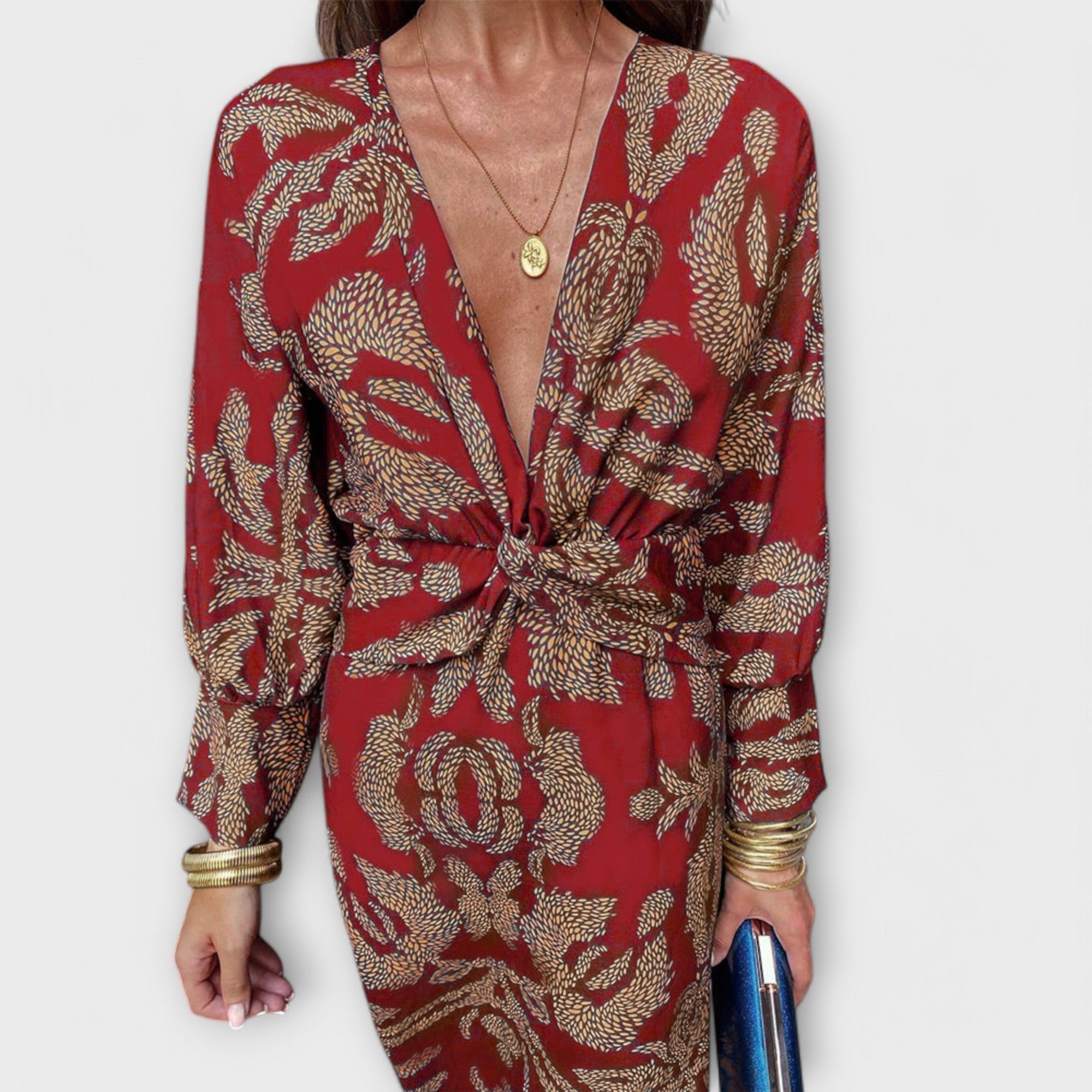 Elegant long-sleeve V-neck dress with red and gold ornate pattern, front knot detail