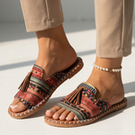 Platform slide sandals with multicolor patterned fabric straps and brown tassels, tan cork sole