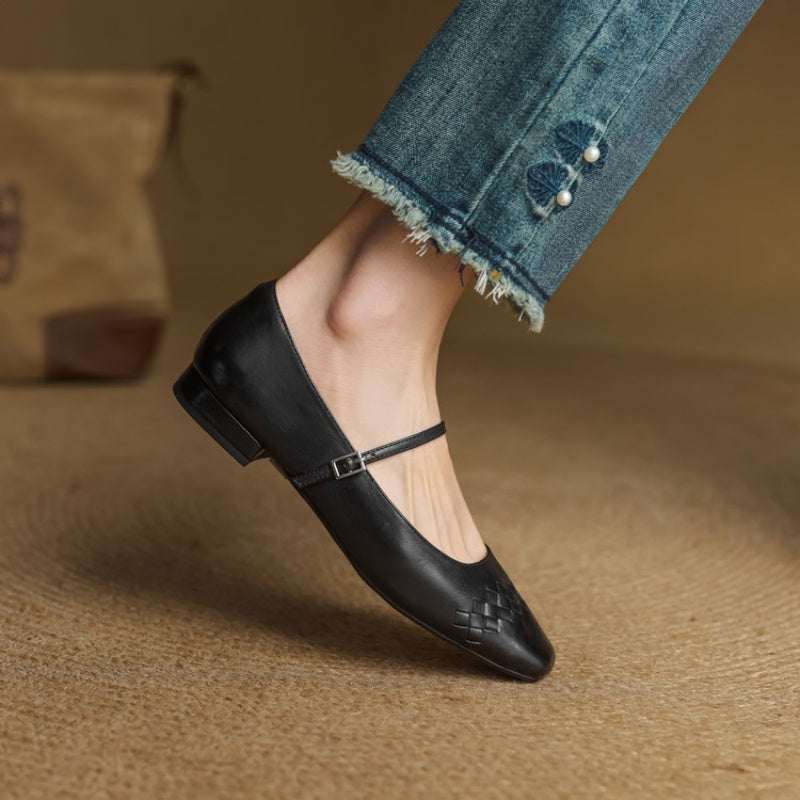 Black square-toe Mary Jane flats with ankle strap and low block heel.