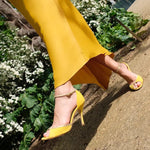 Yellow high-heel peep-toe sandals with ankle strap and medium pointed stiletto heel