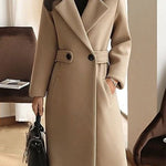 Beige winter coat with notch lapels, front buttons, and waist belt