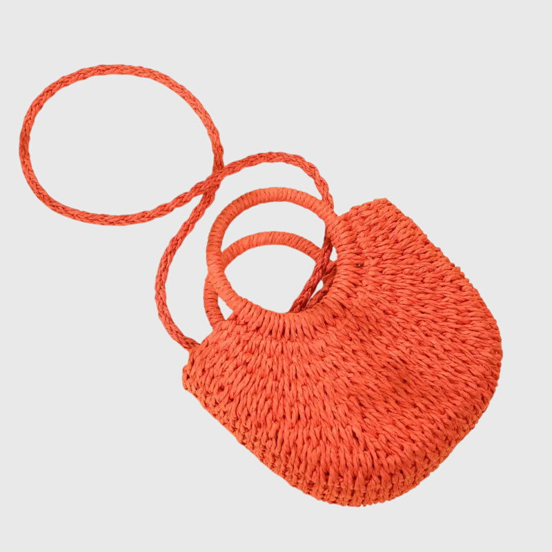 Orange woven straw crossbody bag with two loop handles and adjustable-style strap.