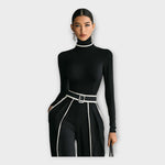 Women's black turtleneck jumpsuit with contrast trim and belted waist, close-up front
