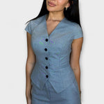 Blue V-neck button-front short-sleeve top with fitted waist and front pocket detail
