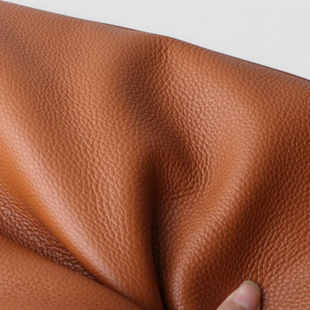 Close-up of brown textured leather-look shoulder bag surface