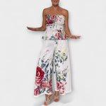 Strapless floral peplum top paired with flowing wide-leg trousers, cream base multicolor
