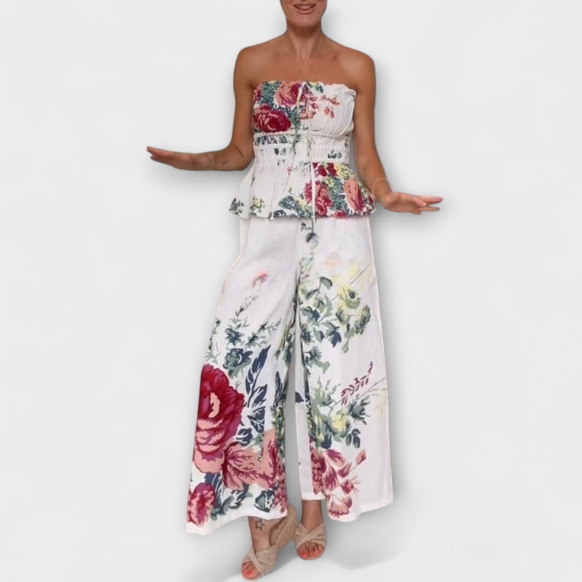 Strapless floral peplum top paired with flowing wide-leg trousers, cream base multicolor