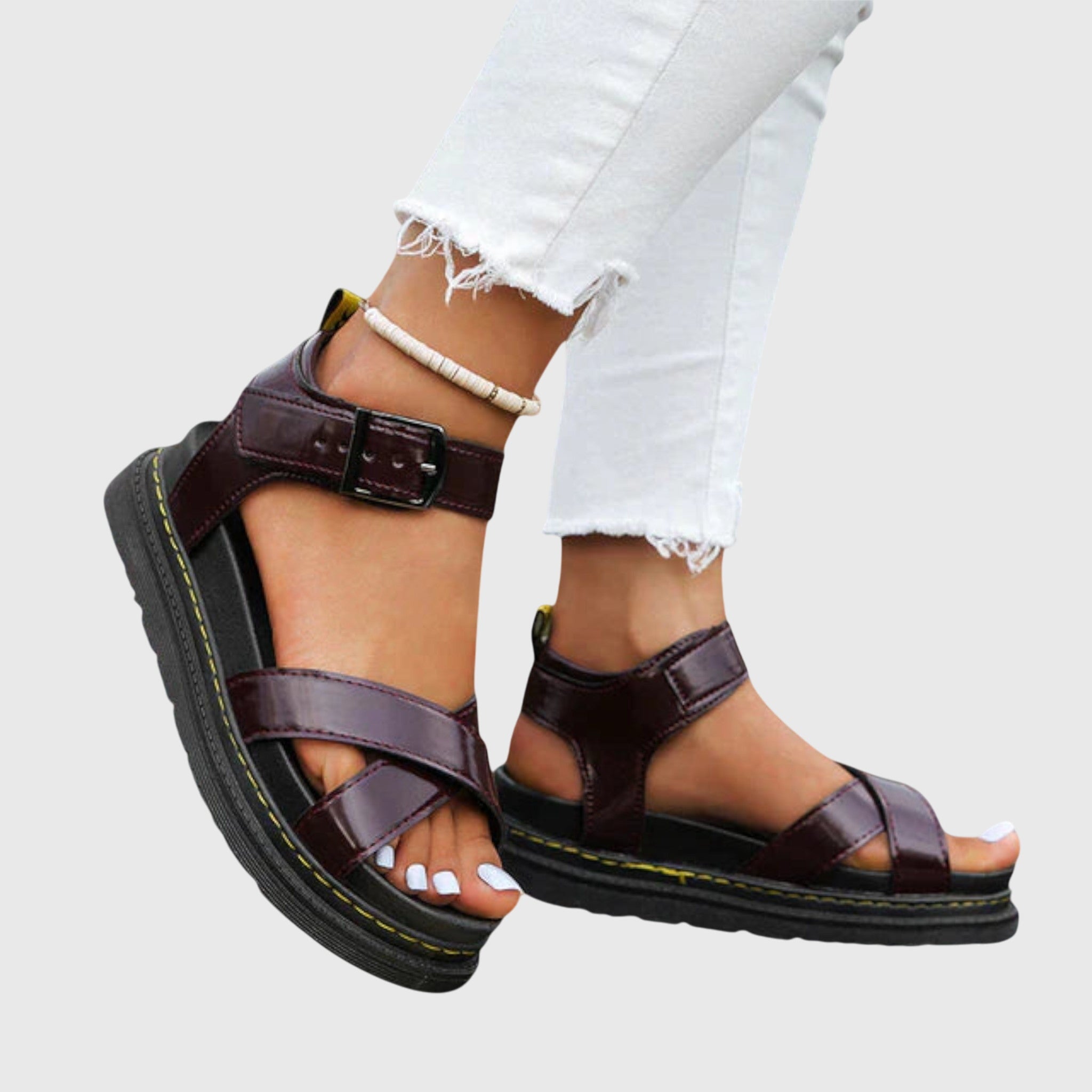 Brown comfort sandals with two straps and buckle, chunky sole with yellow stitching