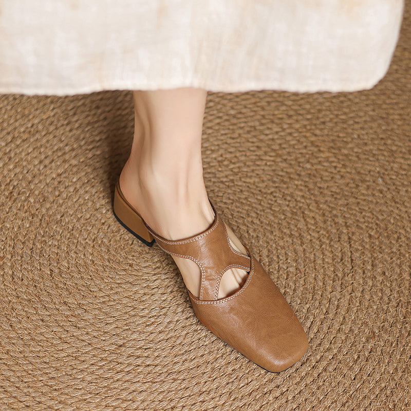 Tan natural leather mule flats, side view showing low block heel and cutout strap