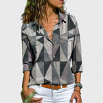 Elegant button-up blouse with gray, black, and white geometric pattern, collared, long sleeves