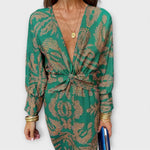 Elegant long-sleeve V-neck dress in green and gold ornate print, front knotted waist