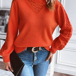 Orange knit pullover sweater with textured V neckline, long sleeves, relaxed fit