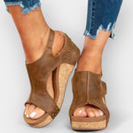 Brown suede platform wedge sandals with studded straps and open toe