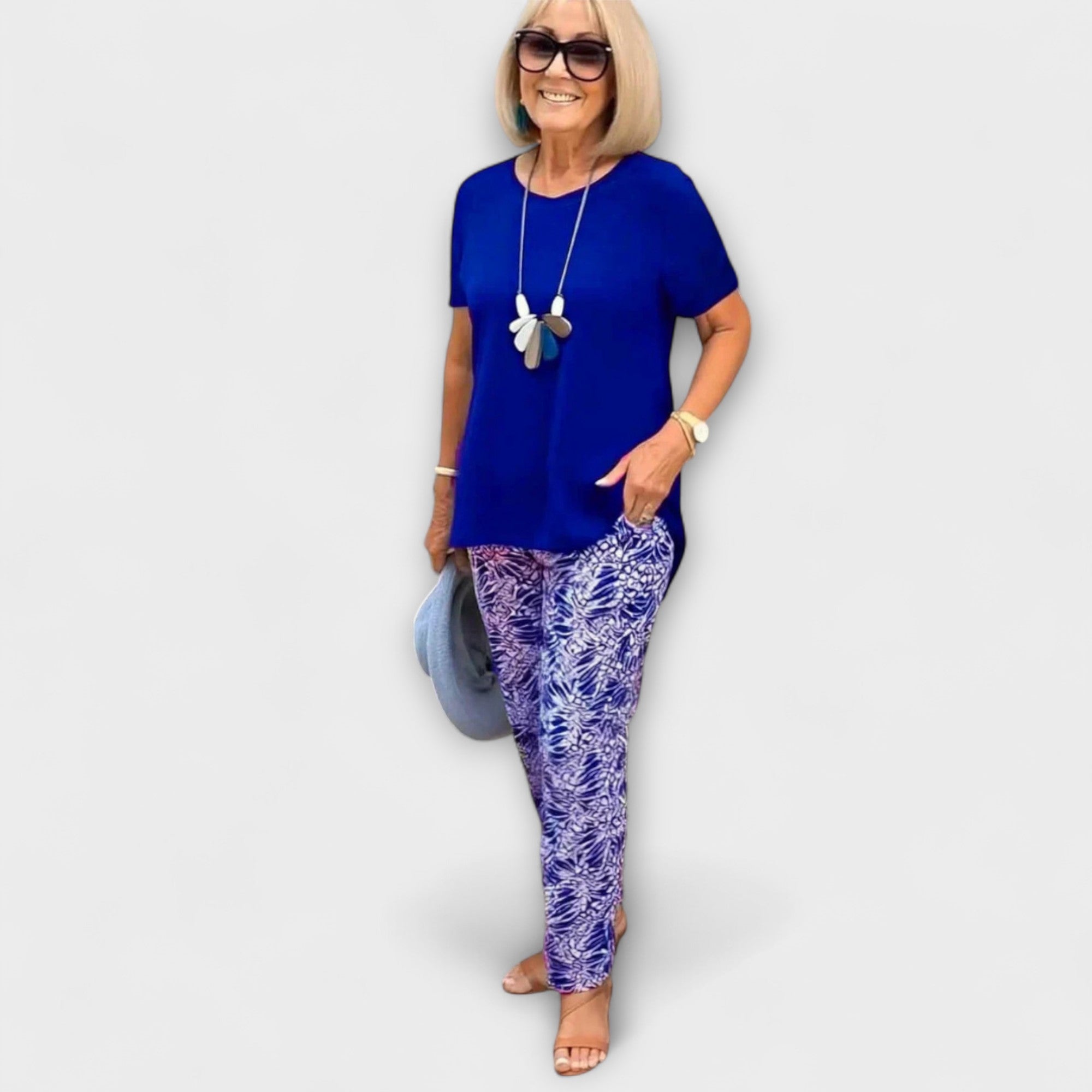 Elegant summer two-piece set featuring dark blue tunic top and blue-white patterned trousers