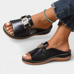 Black slide orthopedic sandal, side view, double gold-tone buckle straps, open toe.