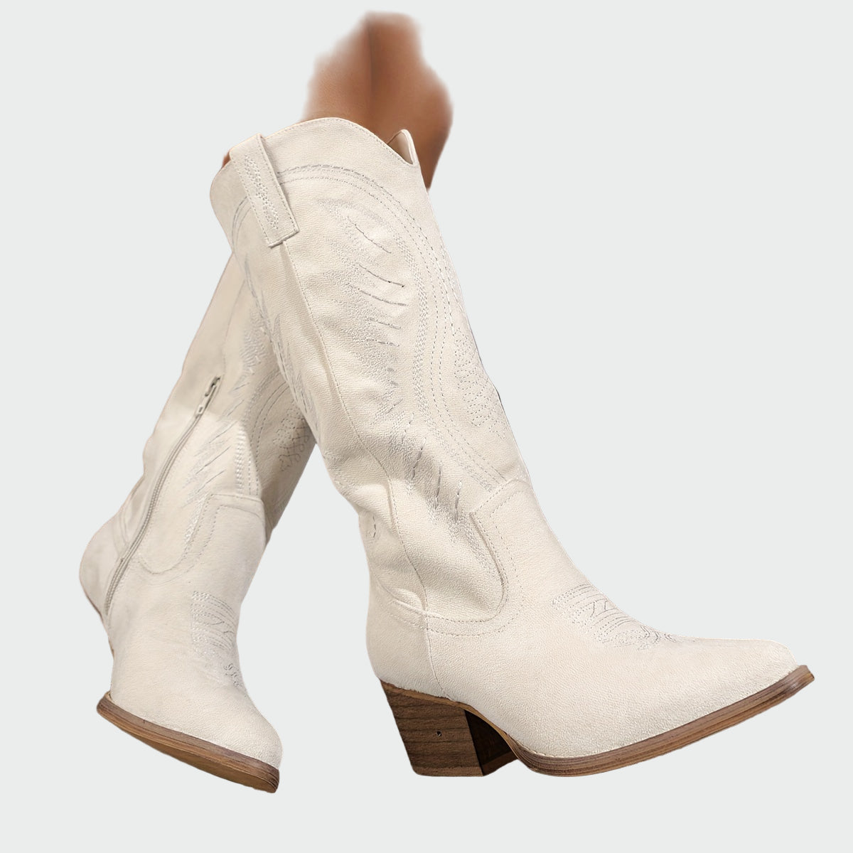 Cream suede mid-calf western boots with decorative stitched embroidery and block heel