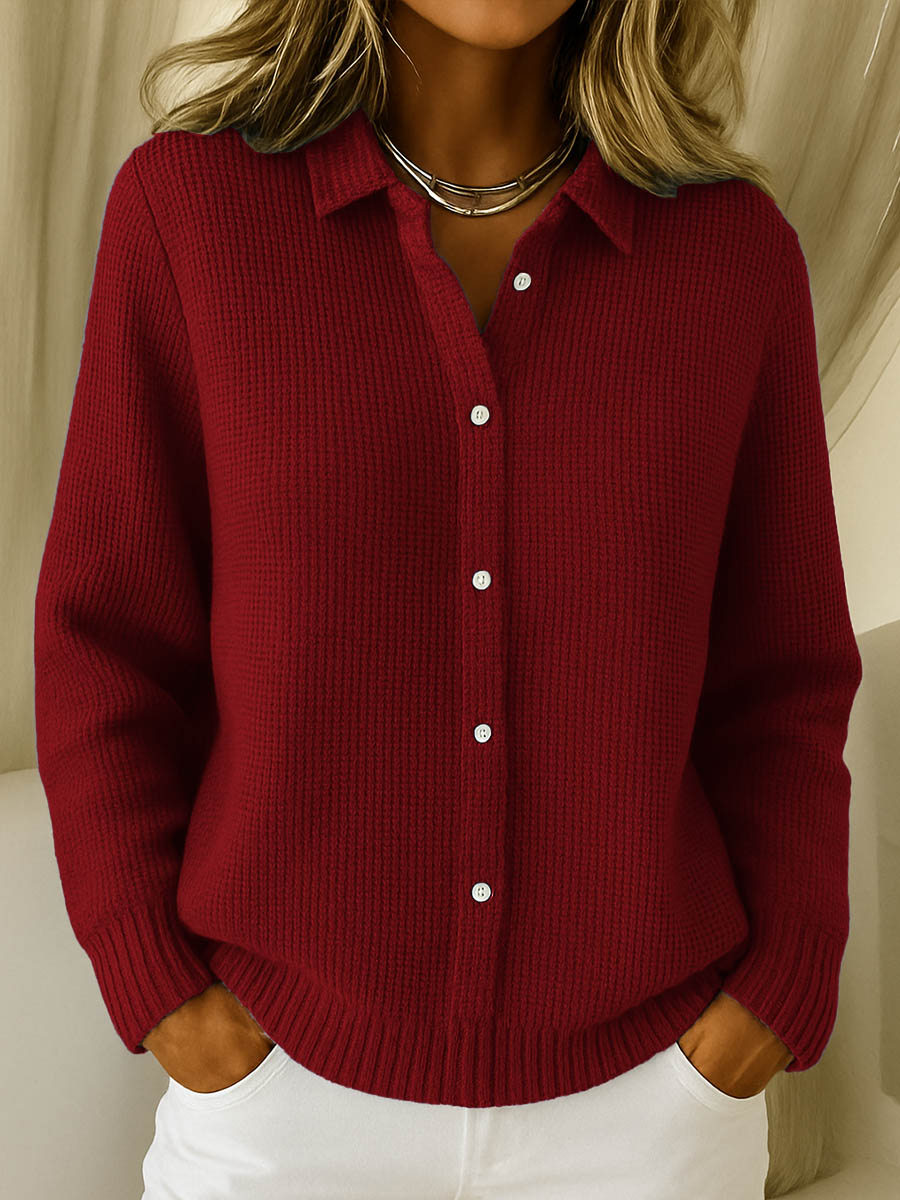 Red knit cardigan with collared button front and ribbed cuffs and hem.