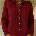 Red knit cardigan with collared button front and ribbed cuffs and hem.