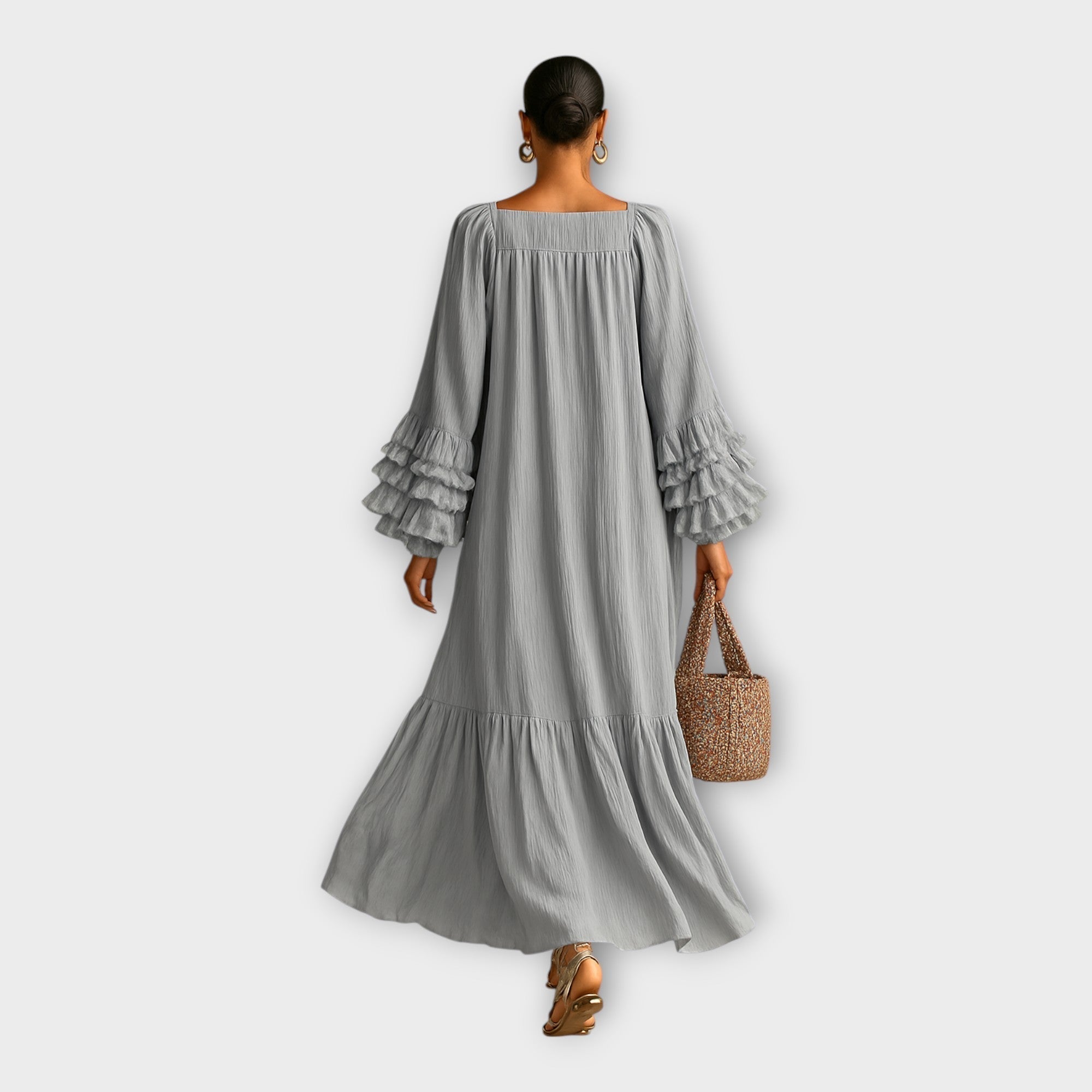 Long gray maxi dress, scoop neckline; tiered skirt and ruffle sleeve cuffs from back