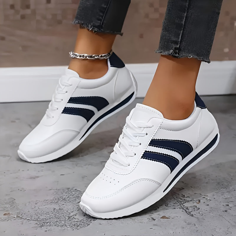 White lace-up orthopedic sneakers with navy stripe detailing and thick cushioned sole