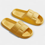 Lightweight slide sandals in yellow, padded strap and ridged footbed, pair view