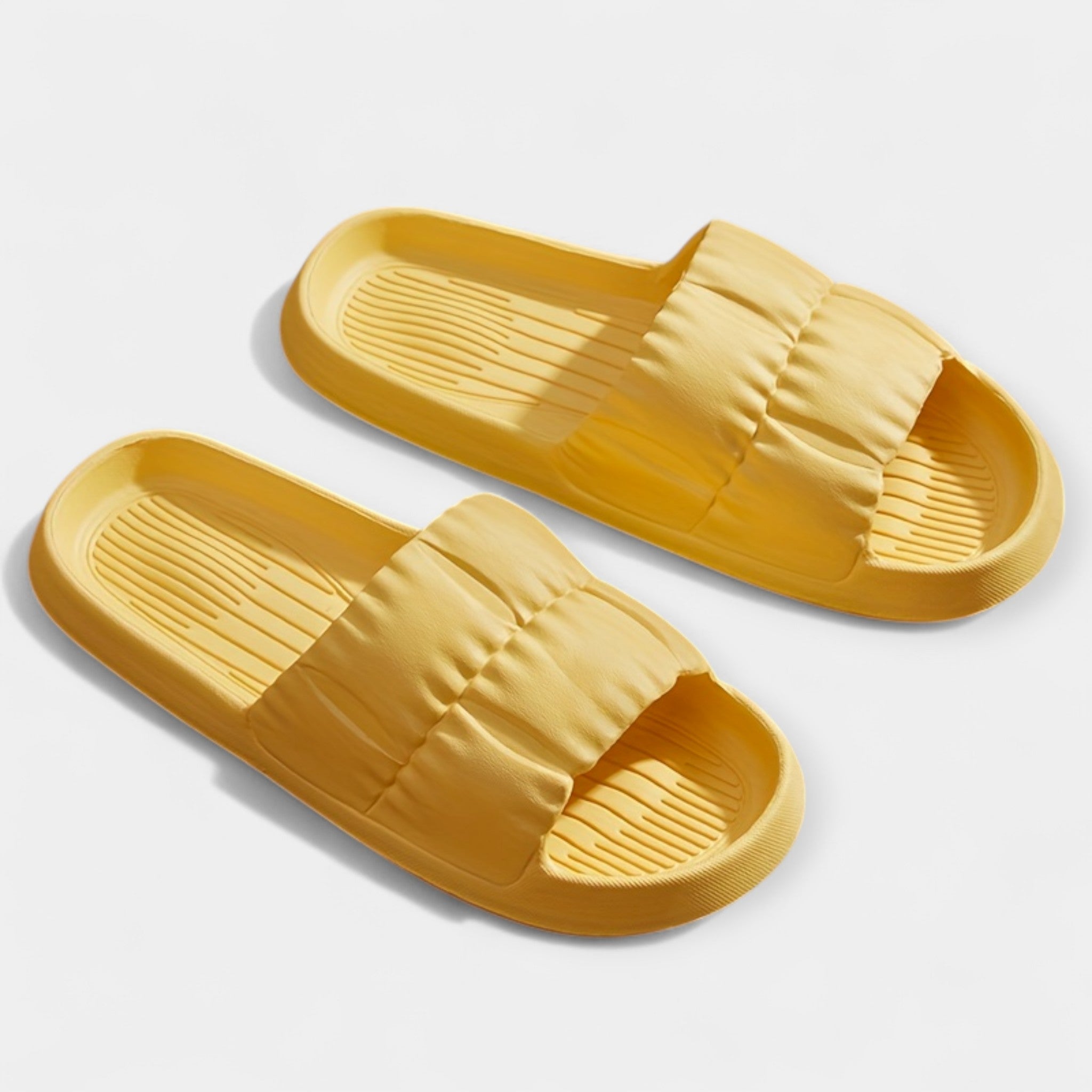 Lightweight slide sandals in yellow, padded strap and ridged footbed, pair view