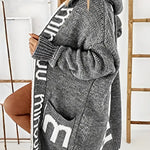 Charcoal-gray hooded knit cardigan with white geometric trim, long sleeves, front pockets