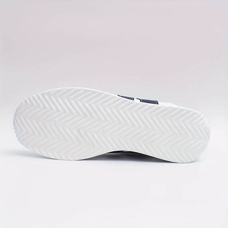 White sneaker outsole with diagonal traction pattern and navy heel detail