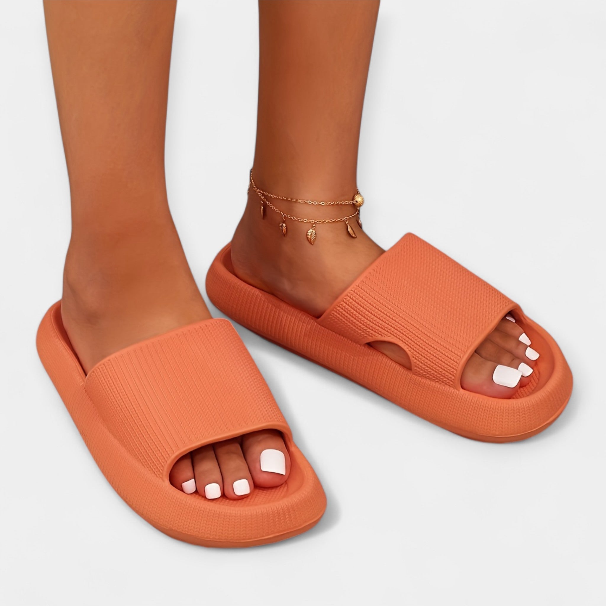 Orange slip-on slide sandals with cushioned sole and textured footbed