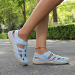 Lightweight summer sandals in light blue on feet with ankle chain detail