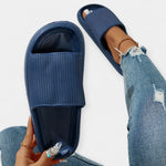 Navy slide sandals with textured footbed and wide strap