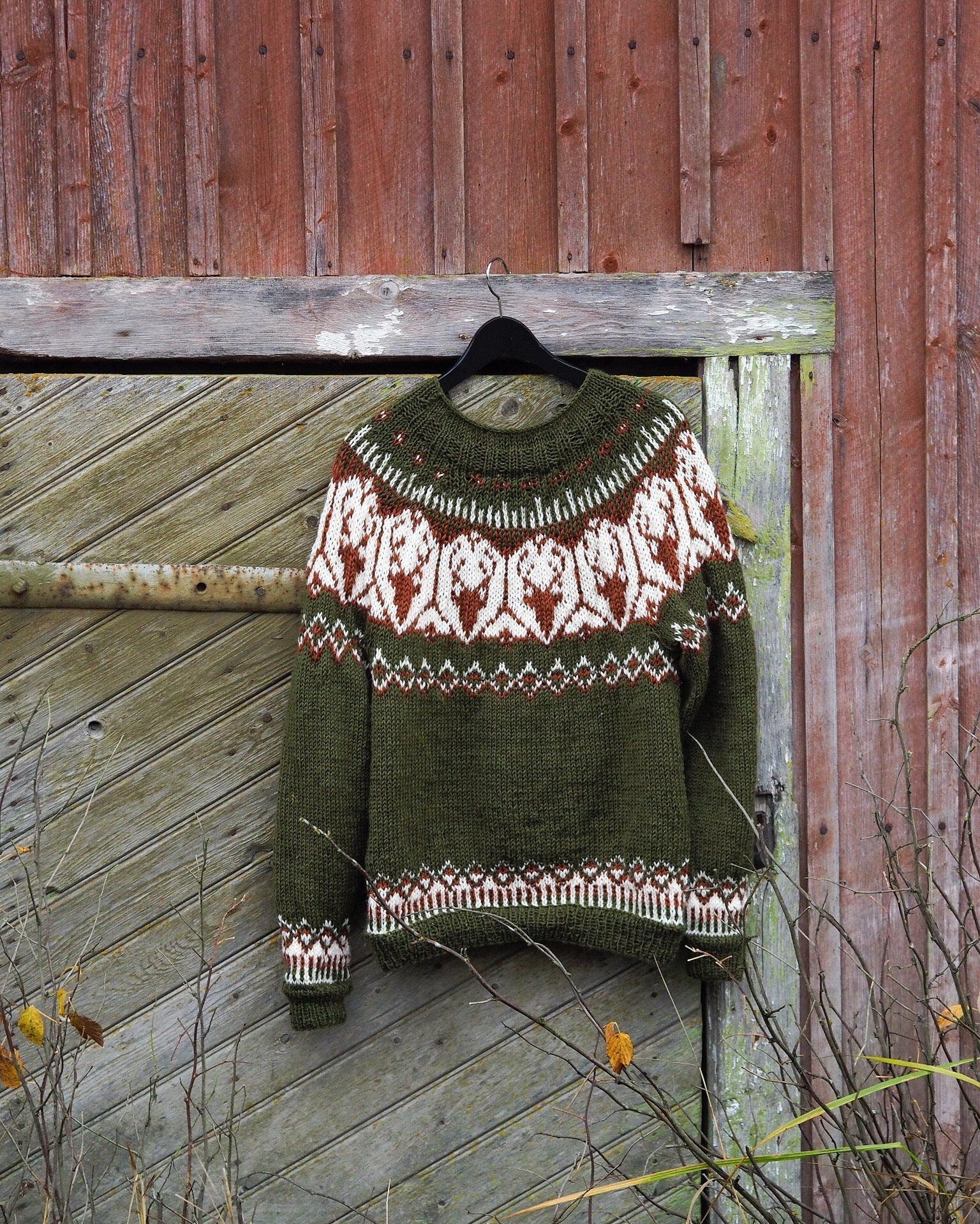 Olive green Fair Isle sweater with white and red geometric yoke, crew neck