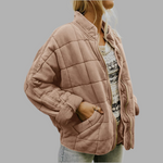 Light brown quilted puffer jacket with zip front, stand collar, and side pockets