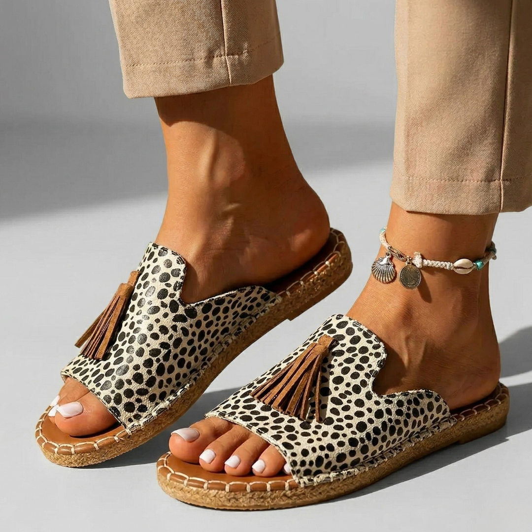Platform slide sandals with leopard-print fabric upper, tan cork sole, tassel detail
