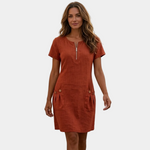 Short red zip-front dress with short sleeves and side button pockets, linen-texture style.