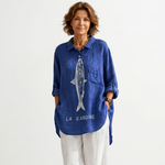 Blue button-front shirt with fish graphic, chest pocket, rolled sleeves