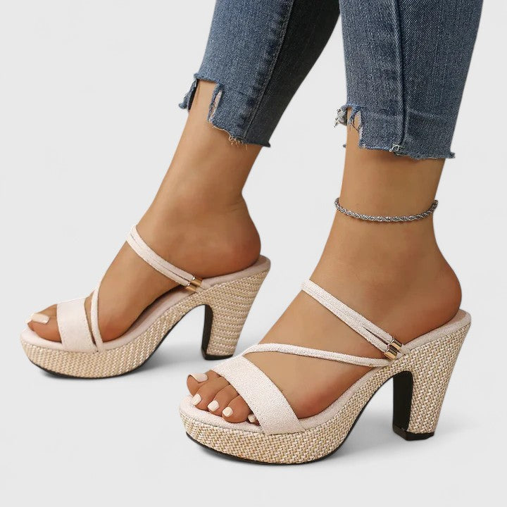 White orthopedic heeled sandals with open toe, ankle strap, and textured platform heel