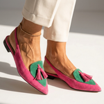 Pink pointed-toe flats with green trim and pink tassel details, flat sole.