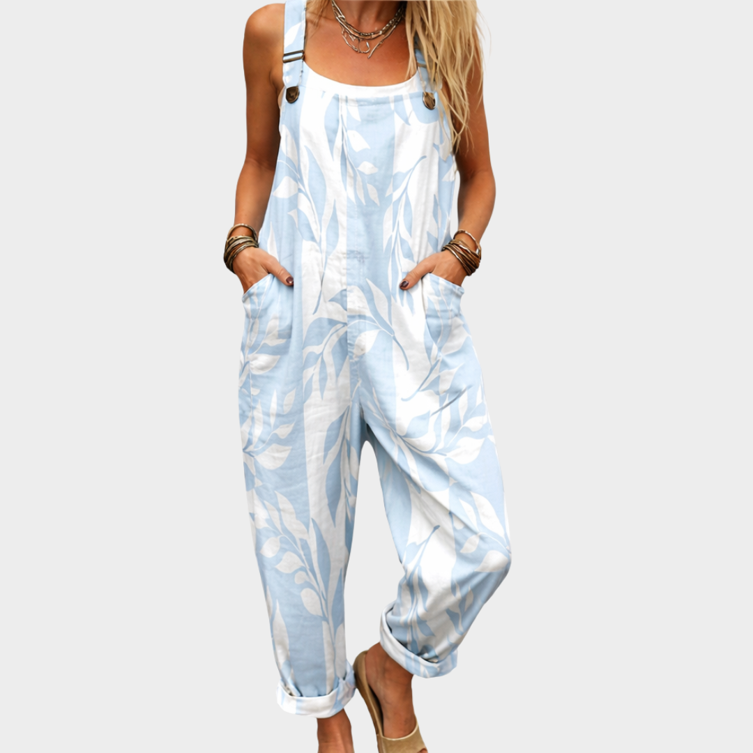 Loose printed overalls in light blue with white pattern, sleeveless bib and front pockets