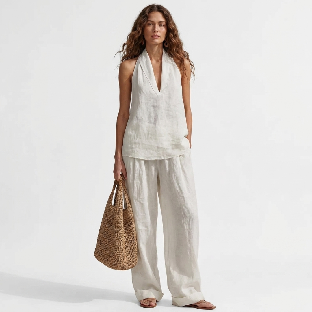 Two-piece V-neck linen set with sleeveless top and wide-leg pants in white.