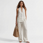 Two-piece V-neck linen set with sleeveless top and wide-leg pants in white.