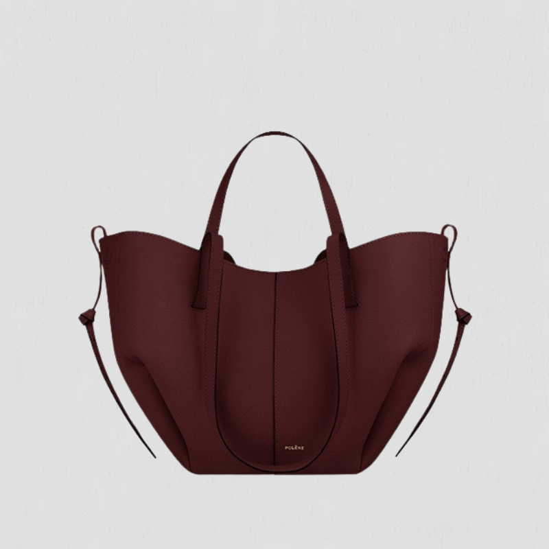 Large burgundy tote bag with top handles and side loop straps, curved open shape