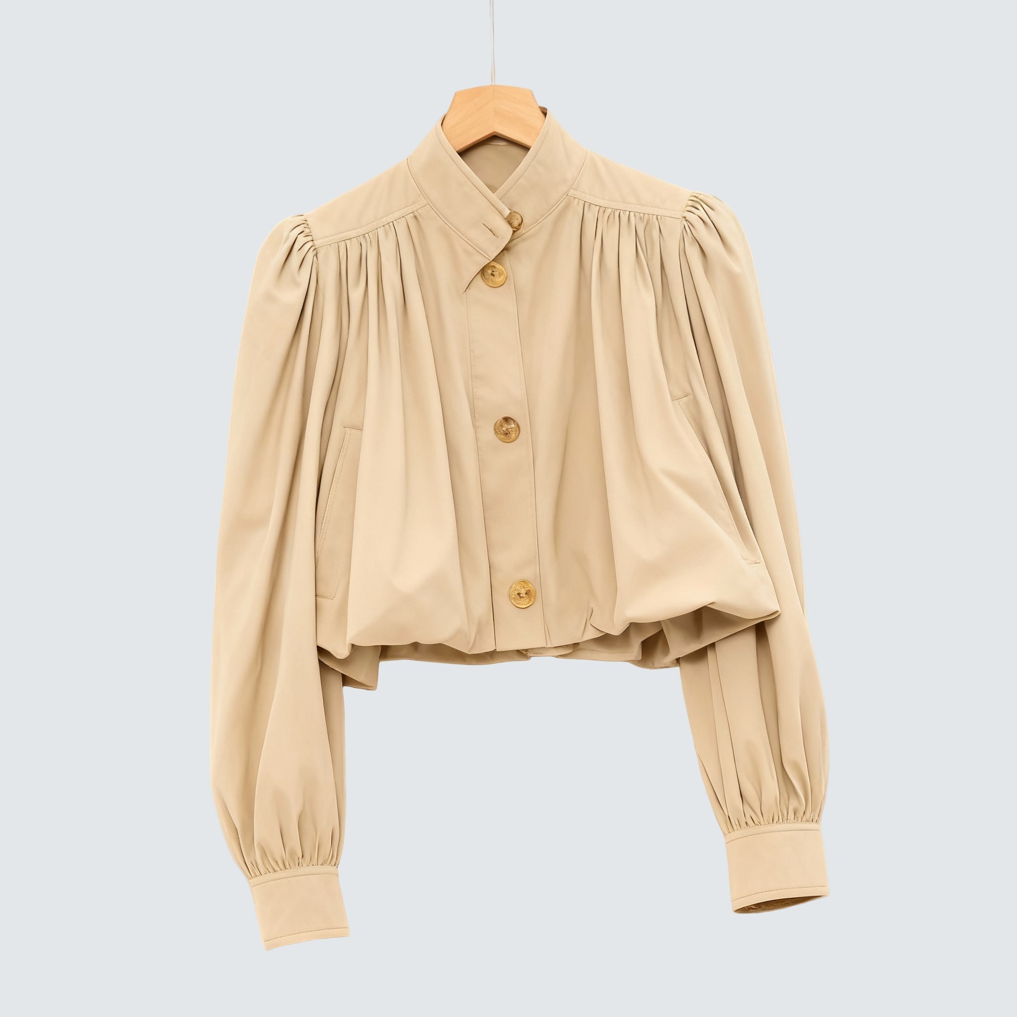 Cream short loose jacket with button front, pleated shoulders, and voluminous sleeves