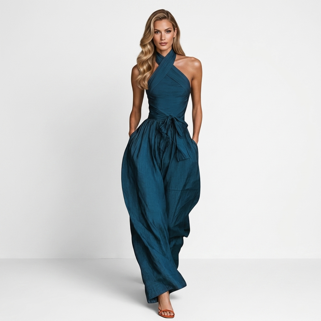 Women's dark teal halter jumpsuit with crossed neckline, gathered waist, wide-leg pants